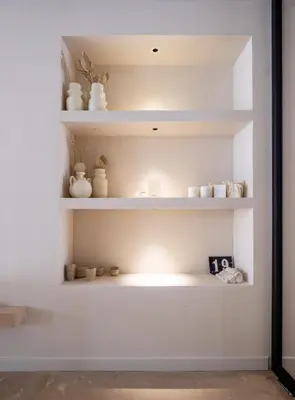 a room with white shelves with ceramics on them at YOURS boutique stay in Valencia