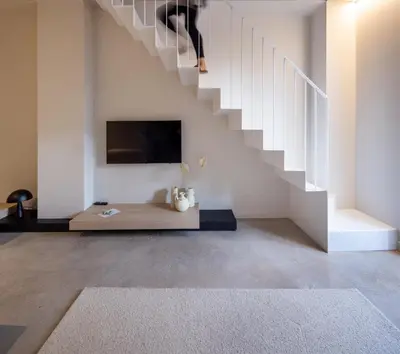 a living room with a tv and a staircase at YOURS boutique stay in Valencia