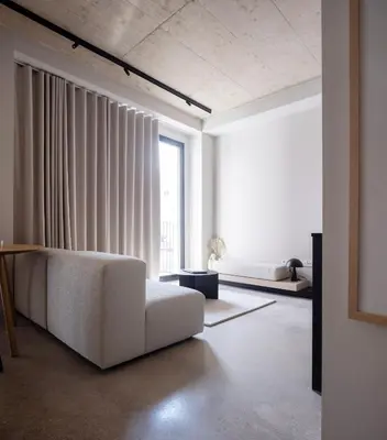 a living room with a white couch and a large window at YOURS boutique stay in Valencia