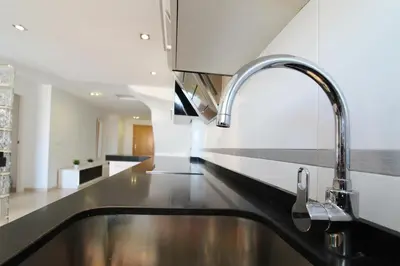 a kitchen with a sink and a faucet at Global Vacacional, Impresionante ático para 8 personas en Canet d'en Berenguer in Canet de Berenguer