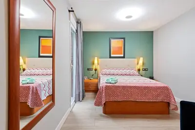 a small bedroom with a bed and a dresser at Burriana Centro in Burriana