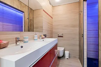 a kitchen with blue cabinets and a counter with stools at Burriana Centro in Burriana