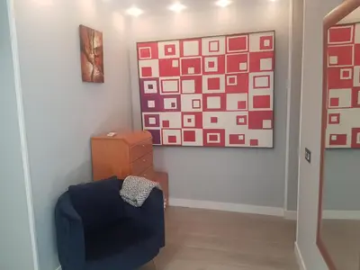 a dining room and living room with a table and chairs at Burriana Centro in Burriana