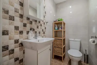 a bathroom with a white sink and a toilet at Apartamento Playa Valencia Beach in Valencia