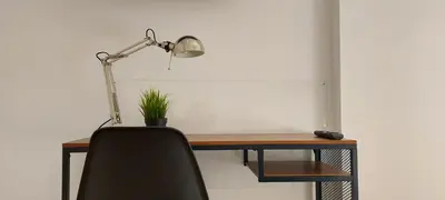 a desk with a chair and a lamp on it at Apartamento Playa Valencia Beach in Valencia