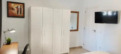 a room with a white cabinet with a television on it at Apartamento Playa Valencia Beach in Valencia