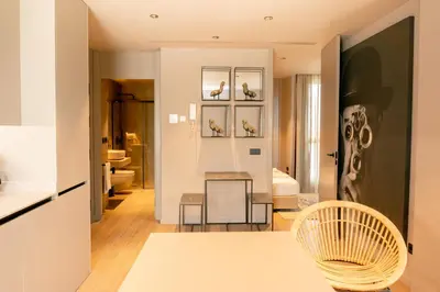a living room with a chair and a table at Valencia Luxury - Sea Port I in Valencia