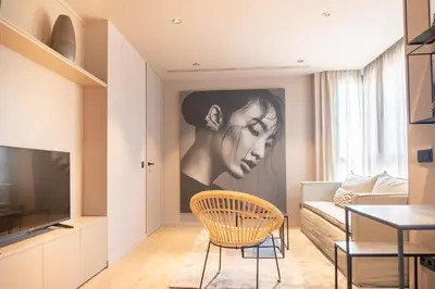 a living room with a painting of a woman on the wall at Valencia Luxury - Sea Port I in Valencia