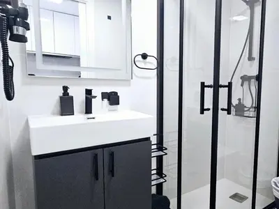 a white bathroom with a sink and a shower at A6 ViviendaTuristicaValencia Ciencias in Valencia
