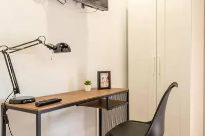 an office with a desk with a chair and a lamp at Valencia Playa in Valencia