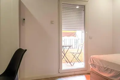 a room with a window with a table and a chair at Valencia Playa in Valencia