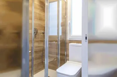 a bathroom with a toilet and a glass shower at Valencia Playa in Valencia