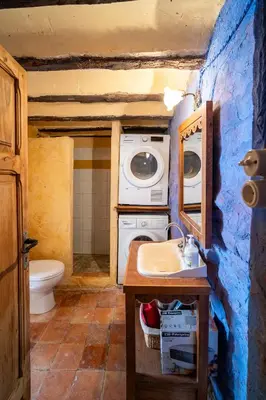 a bathroom with a washing machine and a sink at Casa Museo RAKKANA - En el Centro de Requena in Requena