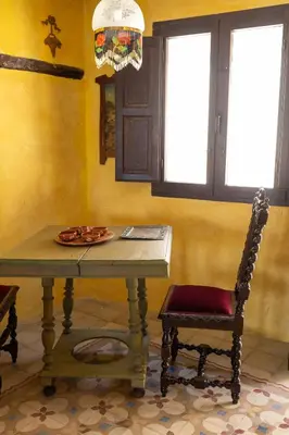a dining room with a table and a chair at Casa Museo RAKKANA - En el Centro de Requena in Requena