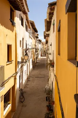 an alley with a bike in an alley between buildings at Casa Museo RAKKANA - En el Centro de Requena in Requena