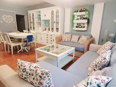 a living room with a couch and a table at Amplio Apartamento Playa Puerto de Sagunto in Puerto de Sagunto