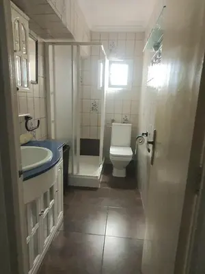 a bathroom with a white toilet and a sink at Amplio Apartamento Playa Puerto de Sagunto in Puerto de Sagunto