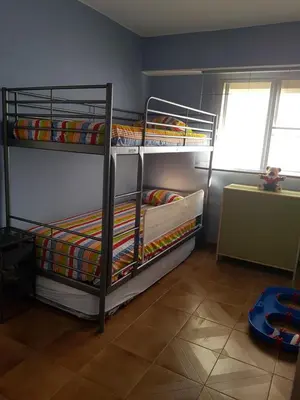 a bedroom with two bunk beds in a room at Amplio Apartamento Playa Puerto de Sagunto in Puerto de Sagunto