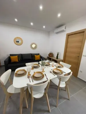 a dining room with a white table and chairs at UIM Mediterraneo Segorbe 1 Wifi in Puerto de Sagunto