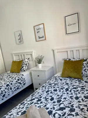 two beds sitting next to each other in a bedroom at UIM Mediterraneo Segorbe 1 Wifi in Puerto de Sagunto