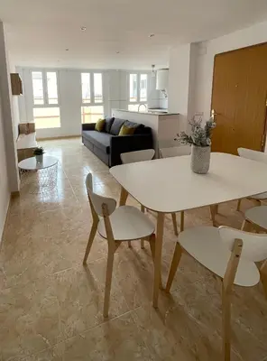 a living room with a table and chairs at UIM Mediterraneo Poeta 3 Wifi in Puerto de Sagunto