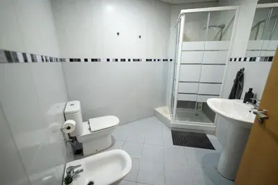 a bathroom with a toilet and a sink and a shower at Apartamento San cayetano in Torrent