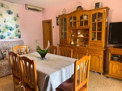 a dining room with a table and chairs and a tv at Villa Barby in Lliria