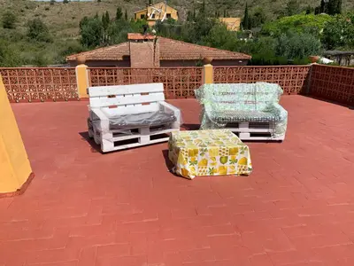 two chairs and a bed on a patio at Villa Barby in Lliria