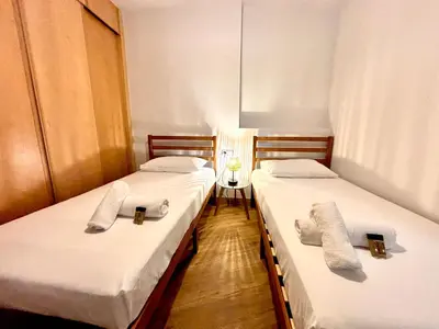 two beds in a room with white towels on them at Casa del Carmen in Valencia