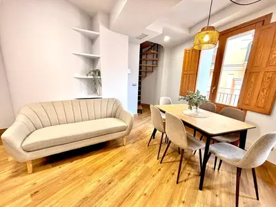 a living room with a couch and a table at Casa del Carmen in Valencia