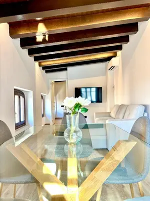 a dining room with a glass table and chairs at Casa Valencians in Valencia