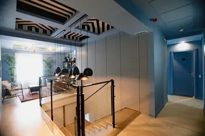 a living room with a glass table and a blue door at The Little Corner B&B in Valencia