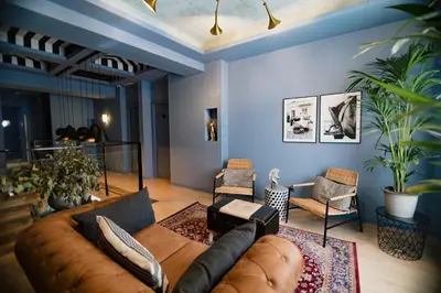 a living room with a large couch and chairs at The Little Corner B&B in Valencia