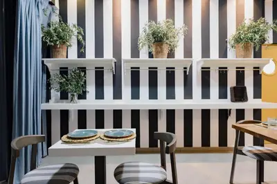a dining room with black and white striped wall at The Little Corner B&B in Valencia