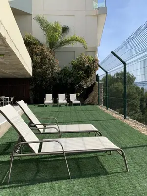 a group of lounge chairs sitting on a lawn at Villa with magnificants sea views on Cullera bay. in Faro de Cullera