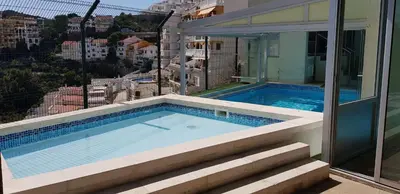 a swimming pool on top of a building at Villa with magnificants sea views on Cullera bay. in Faro de Cullera