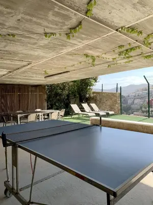 a ping pong table on the roof of a house at Villa with magnificants sea views on Cullera bay. in Faro de Cullera