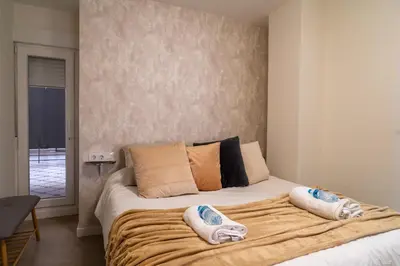 a bedroom with a large bed with two pillows on it at Viva Valencia Apartments in Valencia