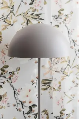 a white lamp in front of a floral wall at Viva Valencia Apartments in Valencia
