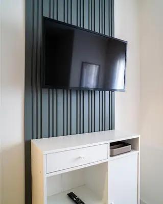 a flat screen tv sitting on top of a white entertainment center at Viva Valencia Apartments in Valencia