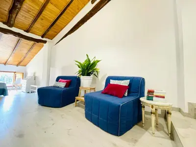 two blue chairs and a table in a living room at JERICA ALOHA in Jérica