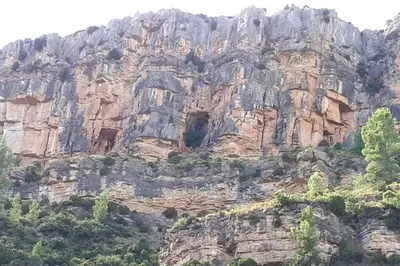 a large rocky mountain with trees in front of it at JERICA ALOHA in Jérica