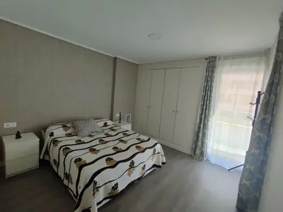 a bedroom with a bed with a black and white blanket at NON STRESS First Level in Valencia