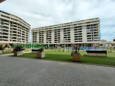 two large buildings with plants inront of a park at NON STRESS First Level in Valencia