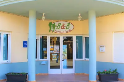 a building with a sign on the front of it at Hostal Rural Fidel Garcia Guzman in Chera