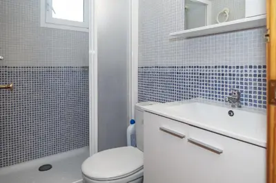 a bathroom with a toilet and a sink and a shower at Mar y Montana 6to 97 in Cullera