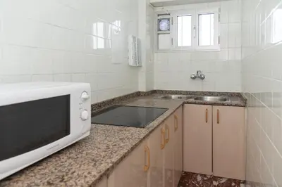 a kitchen with a sink and a microwave on a counter at Mar y Montana 6to 97 in Cullera