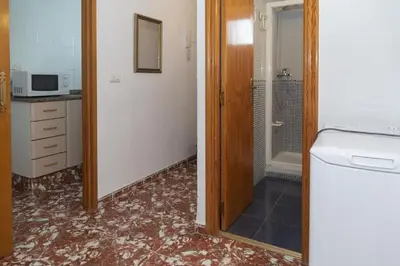 a bathroom with a shower and a sink and a mirror at Mar y Montana 6to 97 in Cullera