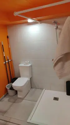 a bathroom with a white toilet in a room at valencialoft in Valencia
