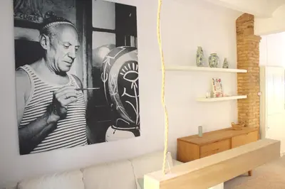 a living room with a black and white picture on the wall at Piso en el Carmen cerca del Mercado Central in Valencia
